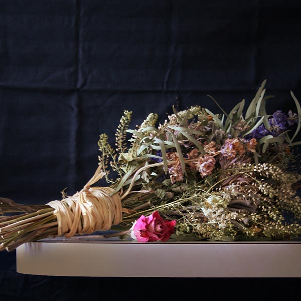a photograph of a bouqet of flowers wrapped in twine.